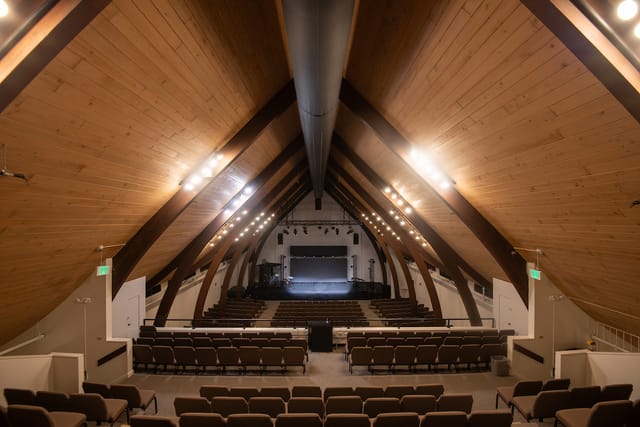 Inside Northwest University’s new chapel, with a tall wood-beamed ceiling over rows of seats