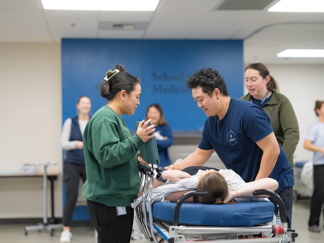 School of Medicine students practice an ultrasound on a classmate in a campus lab