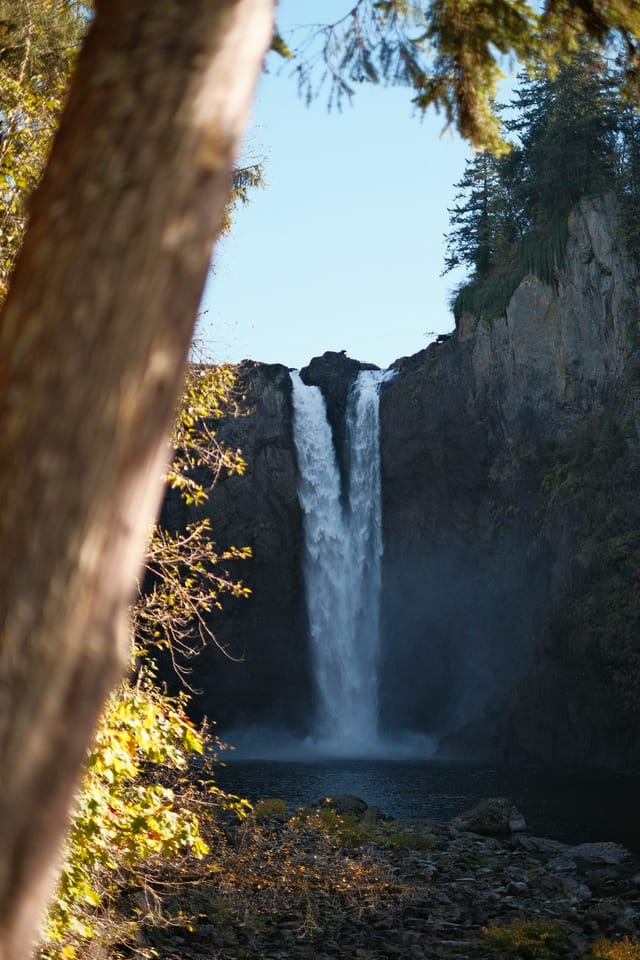Snoqualmie Falls pouring over a rocky cliff into a forested gorge
